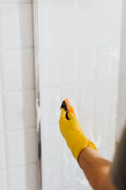 A modern kitchen undergoing renovation, featuring a worker, tools, and materials.